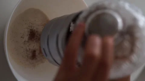 Pour cocoa through a sieve Stock Footage 245700131