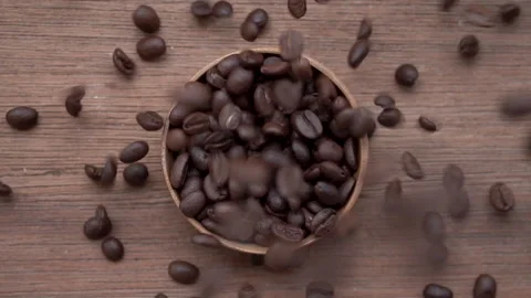 Pour coffee bean into the cup, slow motion, top view Stock Footage 131692491