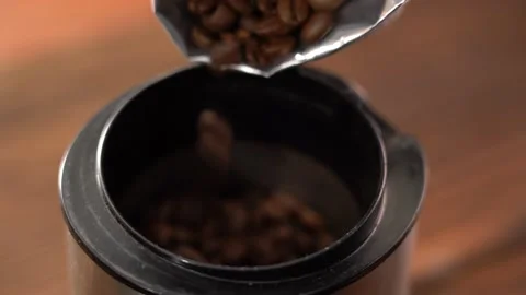 Pour coffee beans into the grinder. Macro video of how coffee beans are pouring Stock Footage 144380377