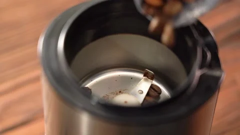 Pour coffee beans into the grinder. Macro video of how coffee beans are pouring Stock Footage 145447488