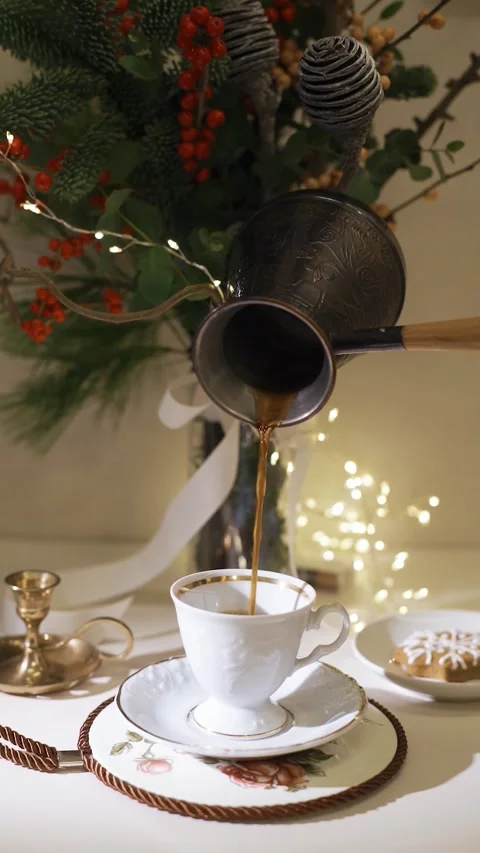 Pour coffee into a cup close-up. Decorated christmas tree on background Stock Footage 224895655