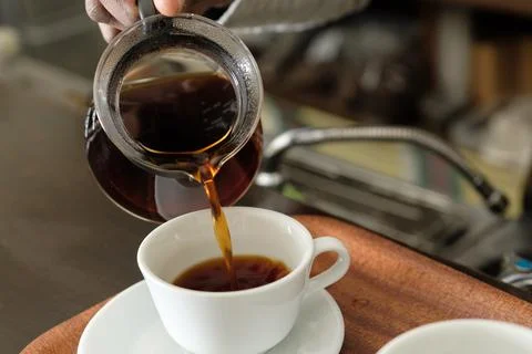 Pour the coffee into the cup Stock Photos