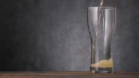 Pour cold light beer in clean glass on gray background Vídeos de archivo 127175244