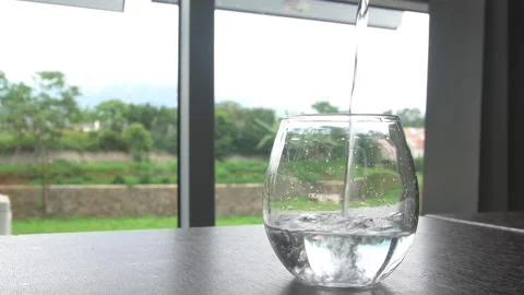 Pour drinking water into a glass Stock Footage 327769396