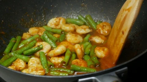 Pour drinking water into the pan, stir fried shrimp , yard long beans, the sp Stock Footage 89493071