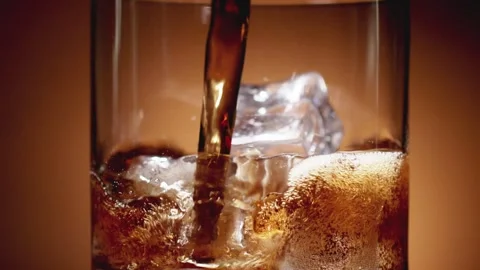 Pour drinks cola ice cubes bubble close-up 動画素材 241296426