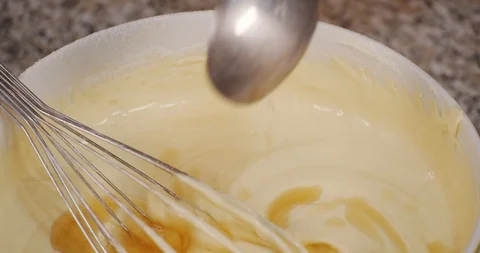 Pour drops of rum into cake dough Stock Footage 129154519