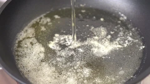 Pour  the egg in fully heated frying pan Stock Footage 131149706