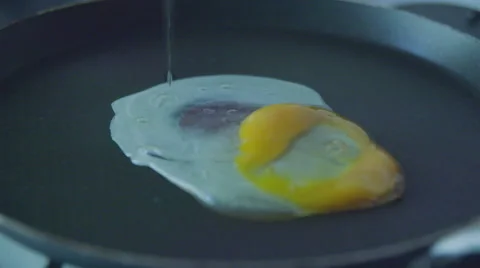 Pour egg in a pan slow motion Stock Footage 57639056