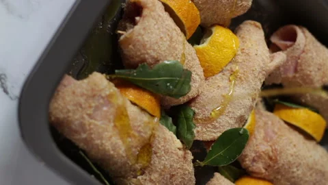 Pour extra virgin olive oil on chicken rolls Stock-Footage 167996776