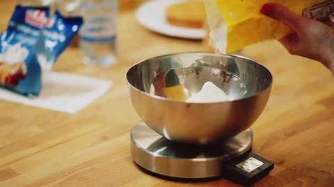 Pour the flour into kitchen scales. A baker makes the cake Video stock 72256717