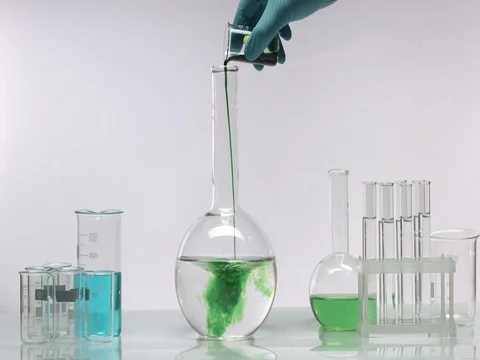 Pour green dye in flask water Stock Footage 69780071