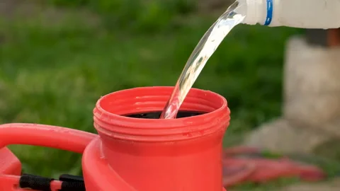 Pour herbicide into the sprayer. Selective focus. Stock Footage 260382204
