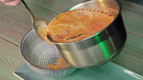 Pour the hot soup into a plate Stock Footage 170233014