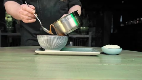 Pour the hot soup into a plate Stock Footage 170233020