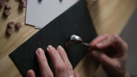 Pour hot wax on the envelope. Print paraffin. Blur. Selective focus. Black envel Stock Footage 147546341