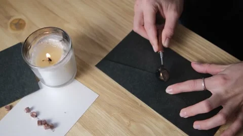Pour hot wax on the envelope. Print paraffin. Blur. Selective focus. Black envel Stock Footage 148404958