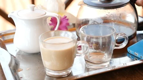 Pour invigorating coffee into two transparent cups. HD, 1920x1080, slow motion Stock Footage 90842352