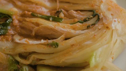 Pour kimchi soup over the plated kimchi. Stock Footage 113898144