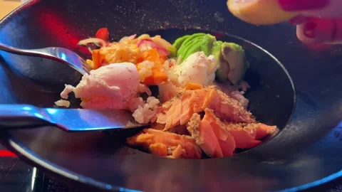 Pour lemon juice poached egg rice fish and avocado woman's hand squeezes juice 動画素材 292687230