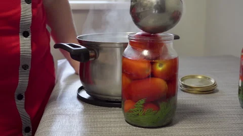 Pour marinade into jars with tomatoes Stock Footage 285591473
