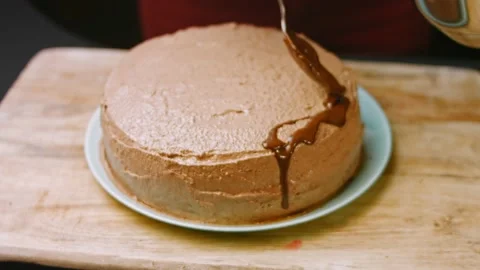 Pour melted chocolate over the chocolate cake. 4k video Stock Footage 164599734