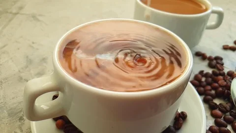 Pour milk into a cup of coffee Stock Footage 117412114