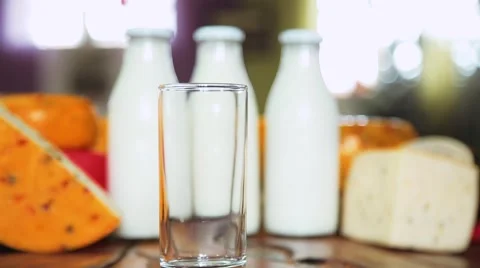 Pour the milk into cup from jug Stock Footage 68940225