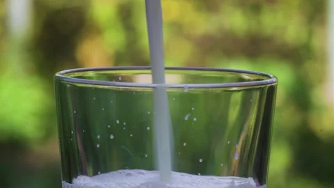 Pour the milk into a glass Stock Footage 247010880