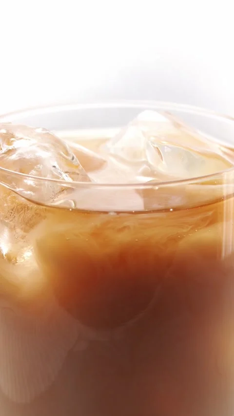 Pour milk into iced tea Stock Footage 331227819