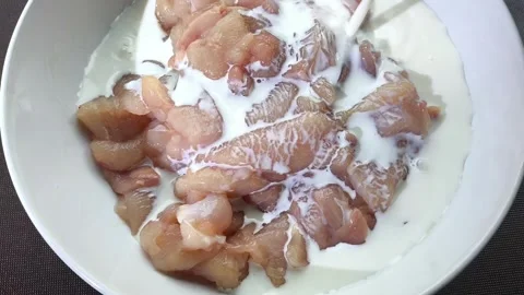 Pour milk on raw chic Stock Footage 315010261