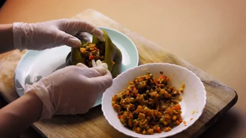 Pour the mixture of ingredients into the baked pepper. I prepare Mexican Stuffed Stock Footage 157783586