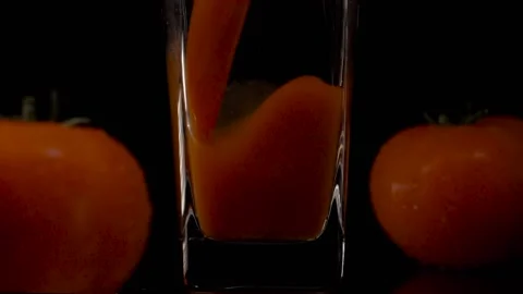 Pour more. Super slow motion shot of pouring tomato juice into a transparent 스톡 동영상 147412099