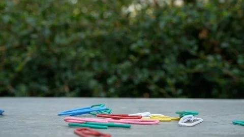 Pour multi color paper clips isolated on grey background. Stock Footage 104603706