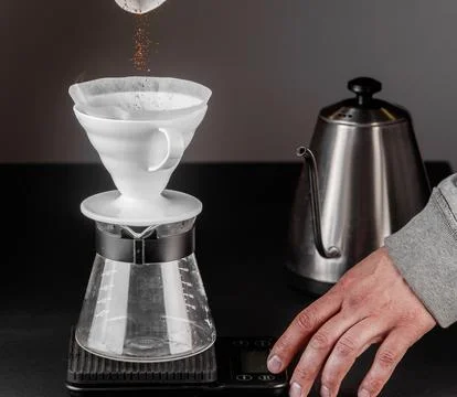 Pour-over alternative method of making coffee. Filter coffee brewing on black Stock Photos