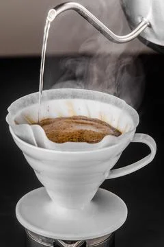 Pour-over alternative method of making coffee. Filter coffee brewing on black Stock Photos