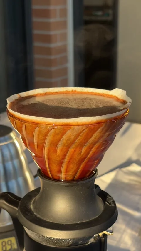 Pour-over coffee brewing process with filter cone and fresh grounds Stock Footage 297373513