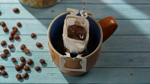 Pour Over Coffee Drip Bag in Mug on Wooden Table 스톡 동영상 332504350