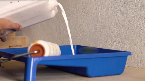Pour the paint into the tray Stock Footage 82735481