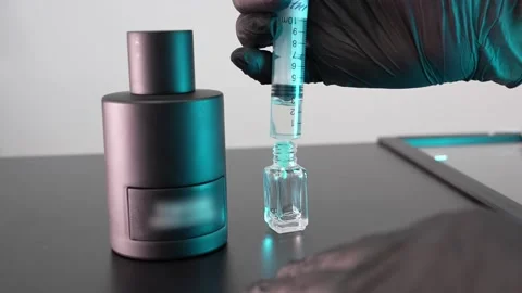 Pour perfume into a small bottle Stock Footage 158463414