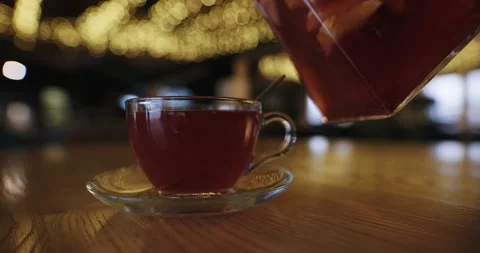 Pour raspberry tea into a cup in luxury restaurant, slow motion Stock Footage 330310735