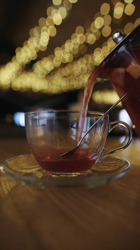 Pour raspberry tea into a cup in restaurant, slow motion vertical video Stock Footage 330310710