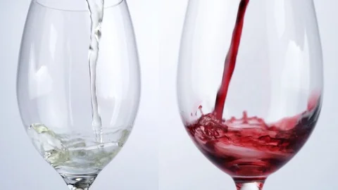 Pour red and white Wine out of a Bottle in a Glass - Slow Motion Stock Footage 125440461