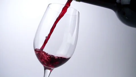 Pour red Wine out of a Bottle in a tilted Glass on - Slow Motion Stock Footage 126100119