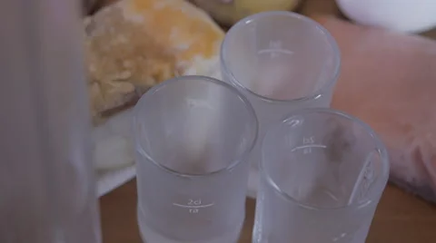 Pour Russian vodka in three stack on the table. Stock Footage 41581987