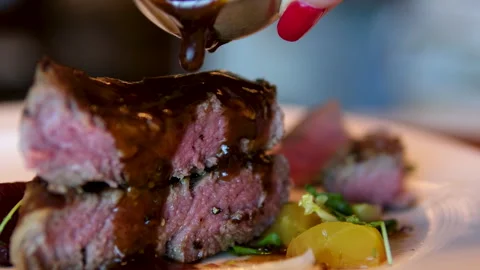 Pour sauce over meat medium grill barbecue cook pours sauce over cooked beef Stock Footage 292018238