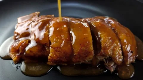Pour sauce on roasted duck Stock Footage 320973560