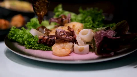 Pour with sauce squid rings fried shrimp Grilled calamari served with fried Stock Footage 302091829