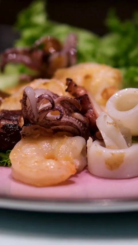 Pour with sauce squid rings fried shrimp Grilled calamari served with fried Stock Footage 302813195