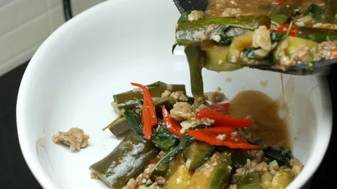 Pour stir fried eggplants with minced pork , herbal sweet basil leaves , red Stock Footage 89447851